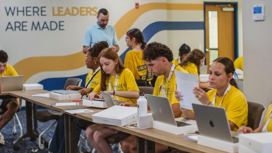 Photo of first-year students receiving their new MacBook Airs
