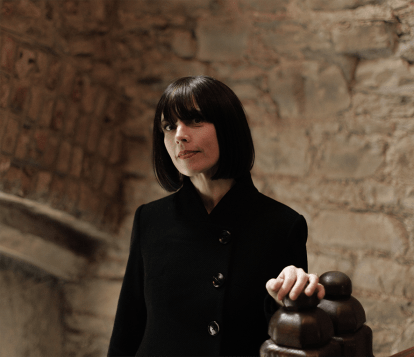 An irish author in a hallway posing for a publicity photo
