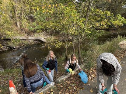 A group of students cleaning up trash.